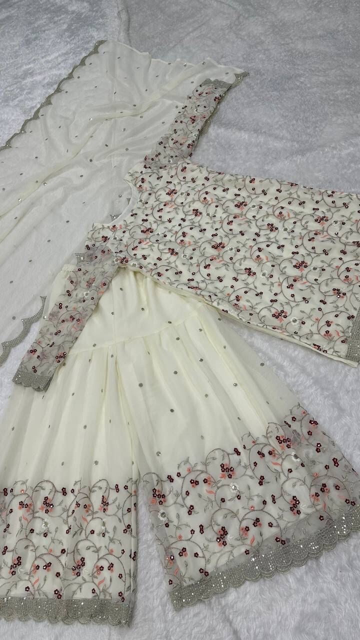 Pakistani Wedding Sharara,
Indian Salwar Kameez Set,
Georgette Sharara Suit,
Off White Sharara Dress,
Sequins and Zari Work Suit,
Wedding Guest Outfit,
Bridal Salwar Kameez,
Scoop Neck Kurta Set,
Full Sleeve Kurti Sharara,
Embroidered Sharara Suit,
Sharara Dress for Reception,
Traditional Wedding Outfit,
Party Wear Salwar Suit,
Elegant Indian Ethnic Wear,
Handmade in India Outfit,
Georgette Dupatta with Sequins,
Long Kurta Sharara Set,
Ready to Wear Sharara Suit,
Zari Embroidery Suit Set,
Flairy Georgette S