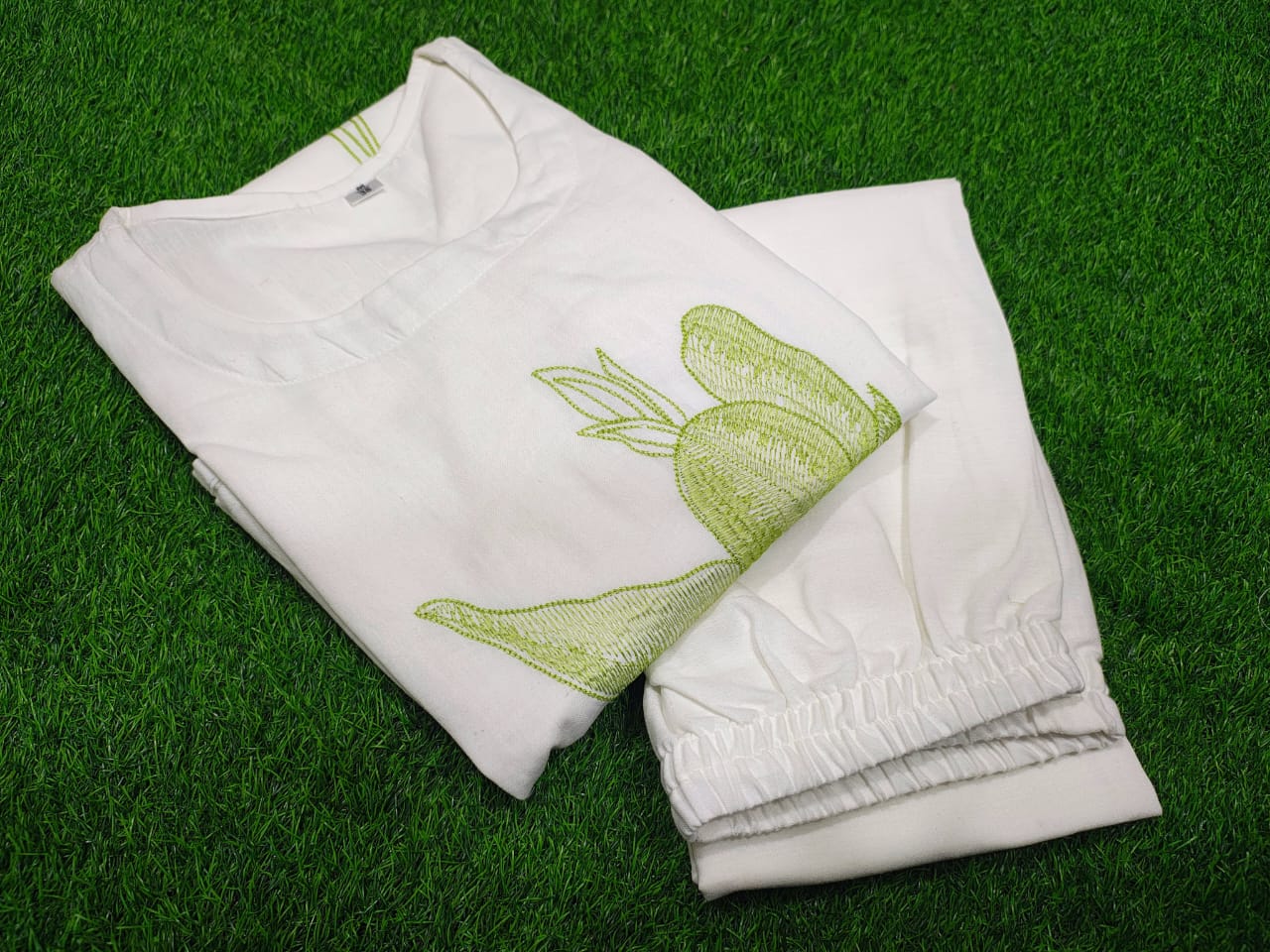 white cotton kurti,white a-line kurti,embroidered white kurti,cotton flex kurta set,green embroidery kurti,stylish white kurta,white kurti with pant,minimalist ethnic wear,modern white kurti,designer cotton kurti,white kurta for women,a-line kurta design,elegant white kurti,white kurti for summer,office wear kurta set,casual white kurti look,indian cotton kurta,pocket pants set,white kurta outfit,hand embroidery kurti,white ethnic dress,women's kurta set,floral embroidered kurti,white kurti with green work,