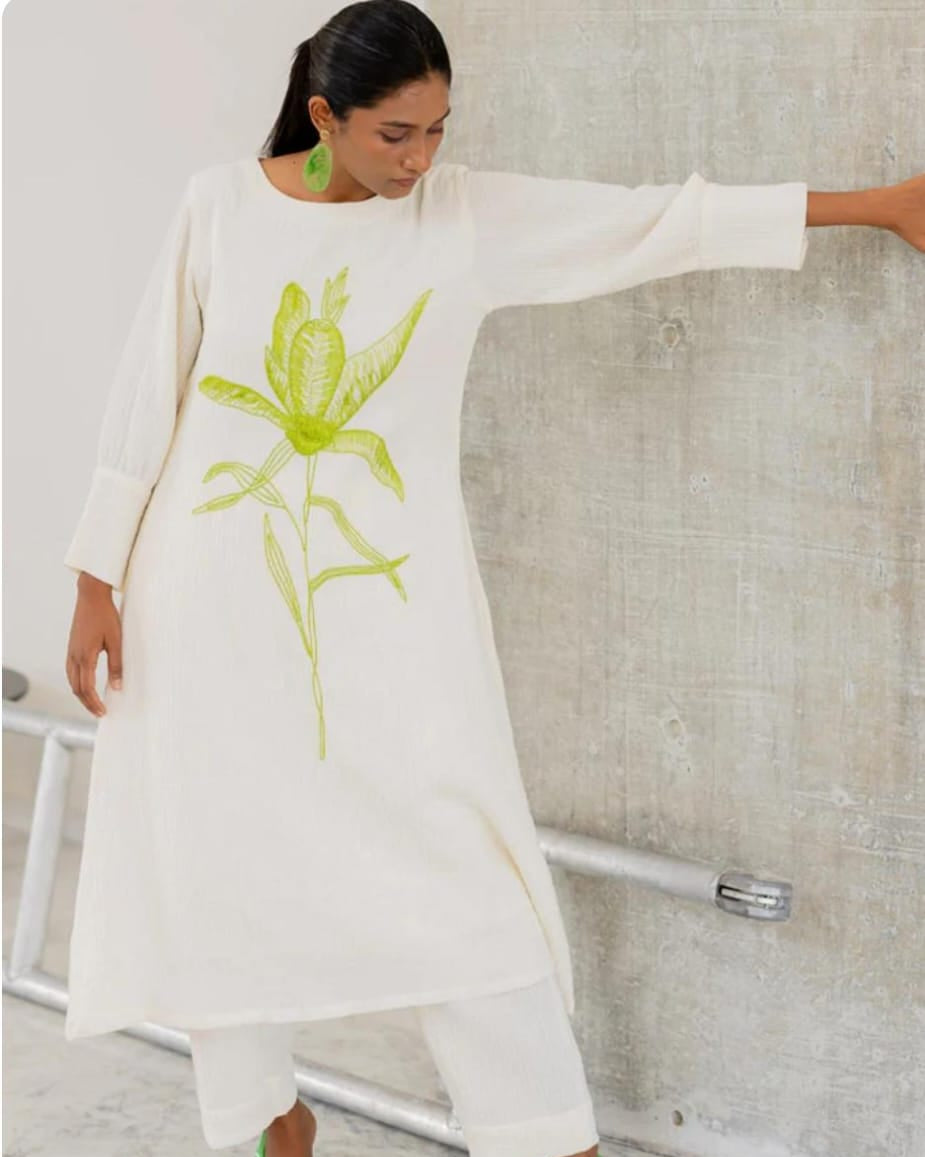 white cotton kurti,white a-line kurti,embroidered white kurti,cotton flex kurta set,green embroidery kurti,stylish white kurta,white kurti with pant,minimalist ethnic wear,modern white kurti,designer cotton kurti,white kurta for women,a-line kurta design,elegant white kurti,white kurti for summer,office wear kurta set,casual white kurti look,indian cotton kurta,pocket pants set,white kurta outfit,hand embroidery kurti,white ethnic dress,women's kurta set,floral embroidered kurti,white kurti with green work,