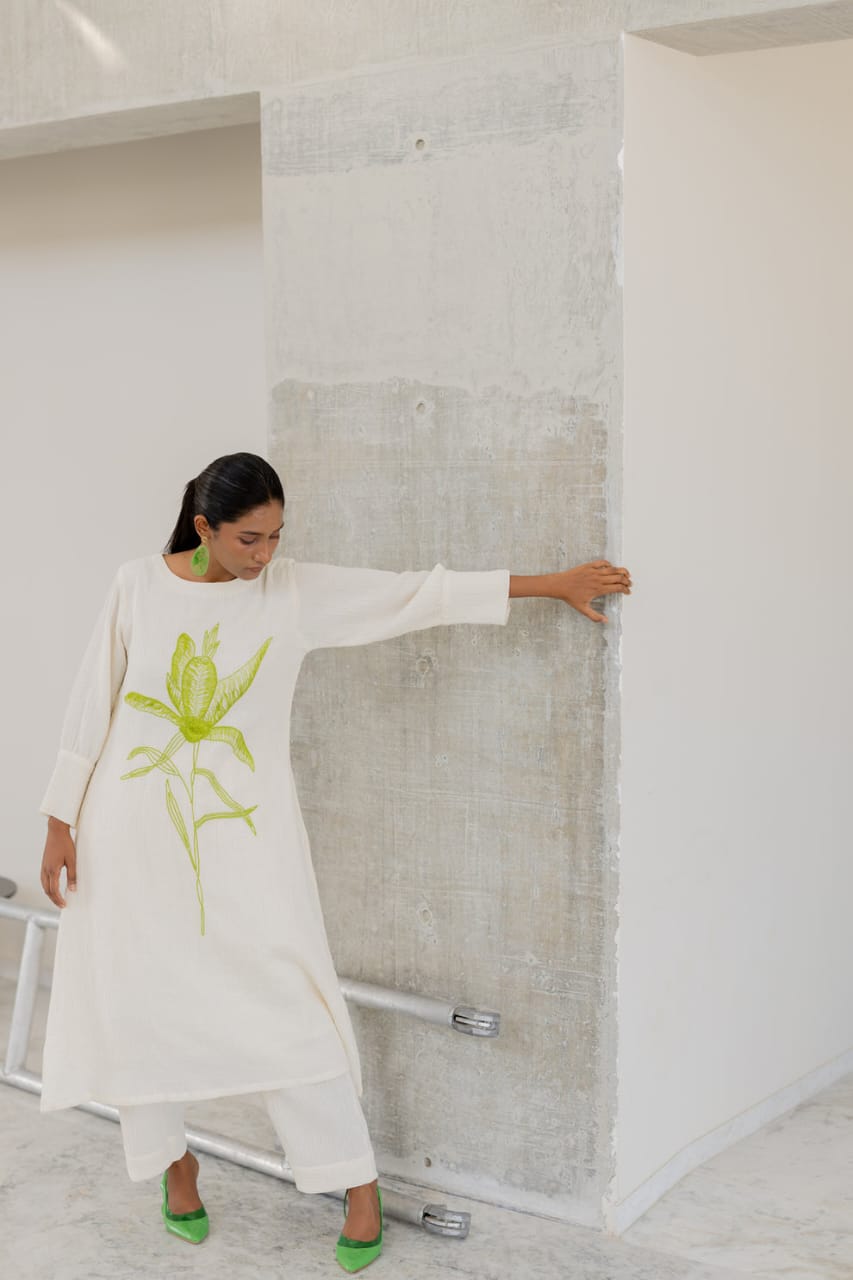 white cotton kurti,white a-line kurti,embroidered white kurti,cotton flex kurta set,green embroidery kurti,stylish white kurta,white kurti with pant,minimalist ethnic wear,modern white kurti,designer cotton kurti,white kurta for women,a-line kurta design,elegant white kurti,white kurti for summer,office wear kurta set,casual white kurti look,indian cotton kurta,pocket pants set,white kurta outfit,hand embroidery kurti,white ethnic dress,women's kurta set,floral embroidered kurti,white kurti with green work,