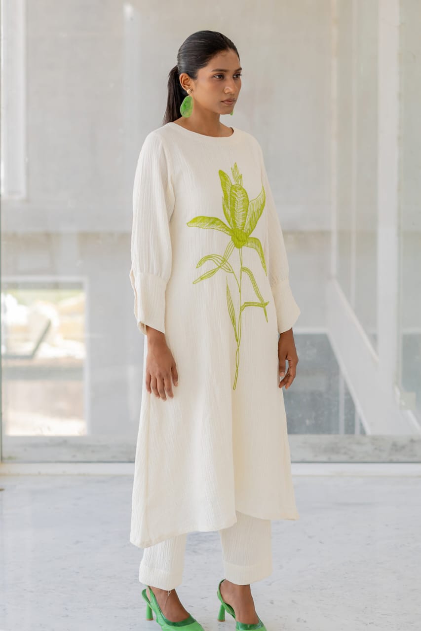 white cotton kurti,white a-line kurti,embroidered white kurti,cotton flex kurta set,green embroidery kurti,stylish white kurta,white kurti with pant,minimalist ethnic wear,modern white kurti,designer cotton kurti,white kurta for women,a-line kurta design,elegant white kurti,white kurti for summer,office wear kurta set,casual white kurti look,indian cotton kurta,pocket pants set,white kurta outfit,hand embroidery kurti,white ethnic dress,women's kurta set,floral embroidered kurti,white kurti with green work,