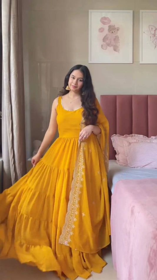 Woman in a yellow dress holding a dupatta