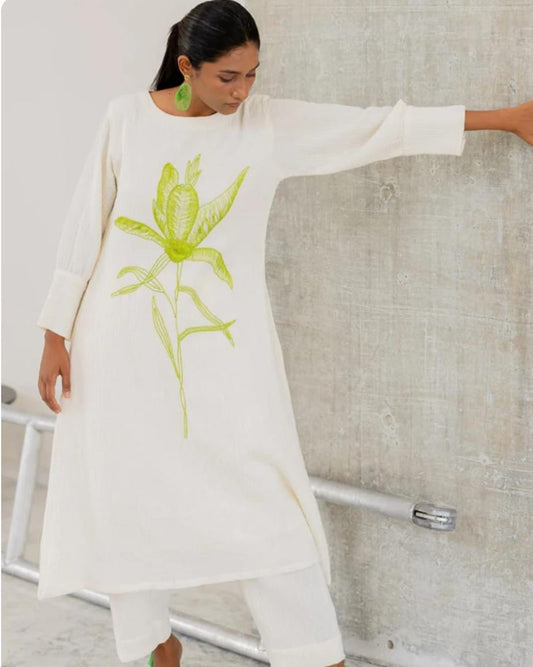 white cotton kurti,white a-line kurti,embroidered white kurti,cotton flex kurta set,green embroidery kurti,stylish white kurta,white kurti with pant,minimalist ethnic wear,modern white kurti,designer cotton kurti,white kurta for women,a-line kurta design,elegant white kurti,white kurti for summer,office wear kurta set,casual white kurti look,indian cotton kurta,pocket pants set,white kurta outfit,hand embroidery kurti,white ethnic dress,women's kurta set,floral embroidered kurti,white kurti with green work,