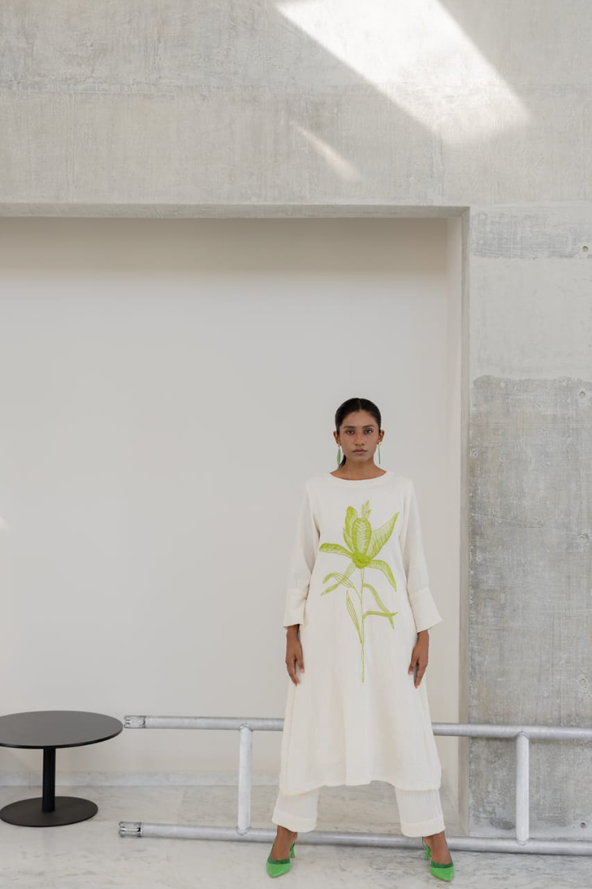 white cotton kurti,white a-line kurti,embroidered white kurti,cotton flex kurta set,green embroidery kurti,stylish white kurta,white kurti with pant,minimalist ethnic wear,modern white kurti,designer cotton kurti,white kurta for women,a-line kurta design,elegant white kurti,white kurti for summer,office wear kurta set,casual white kurti look,indian cotton kurta,pocket pants set,white kurta outfit,hand embroidery kurti,white ethnic dress,women's kurta set,floral embroidered kurti,white kurti with green work,
