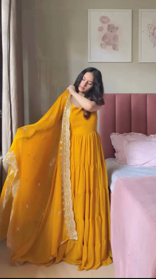 Woman in a yellow dress holding a dupatta