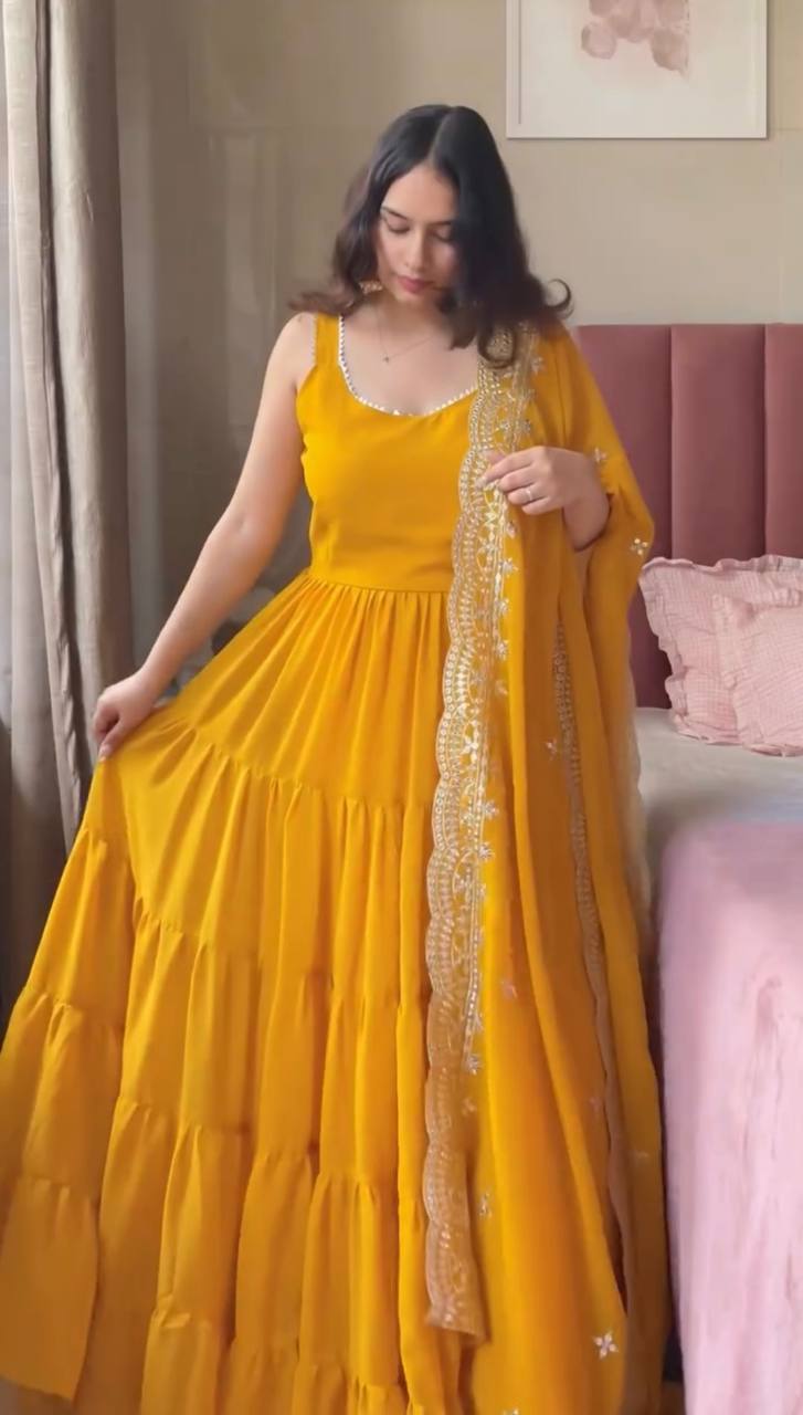 Woman in a yellow dress holding a dupatta