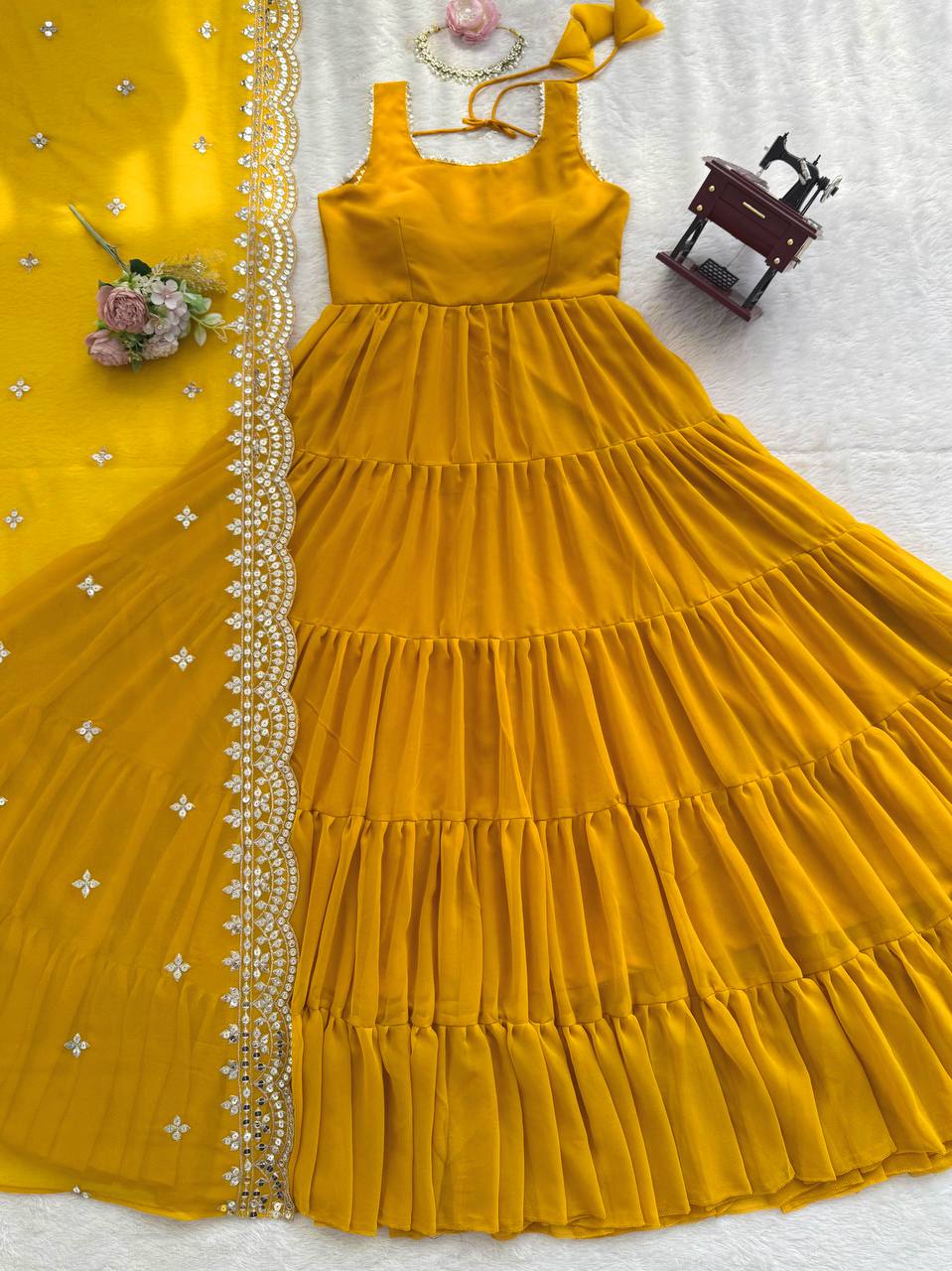 Woman in a yellow dress holding a dupatta