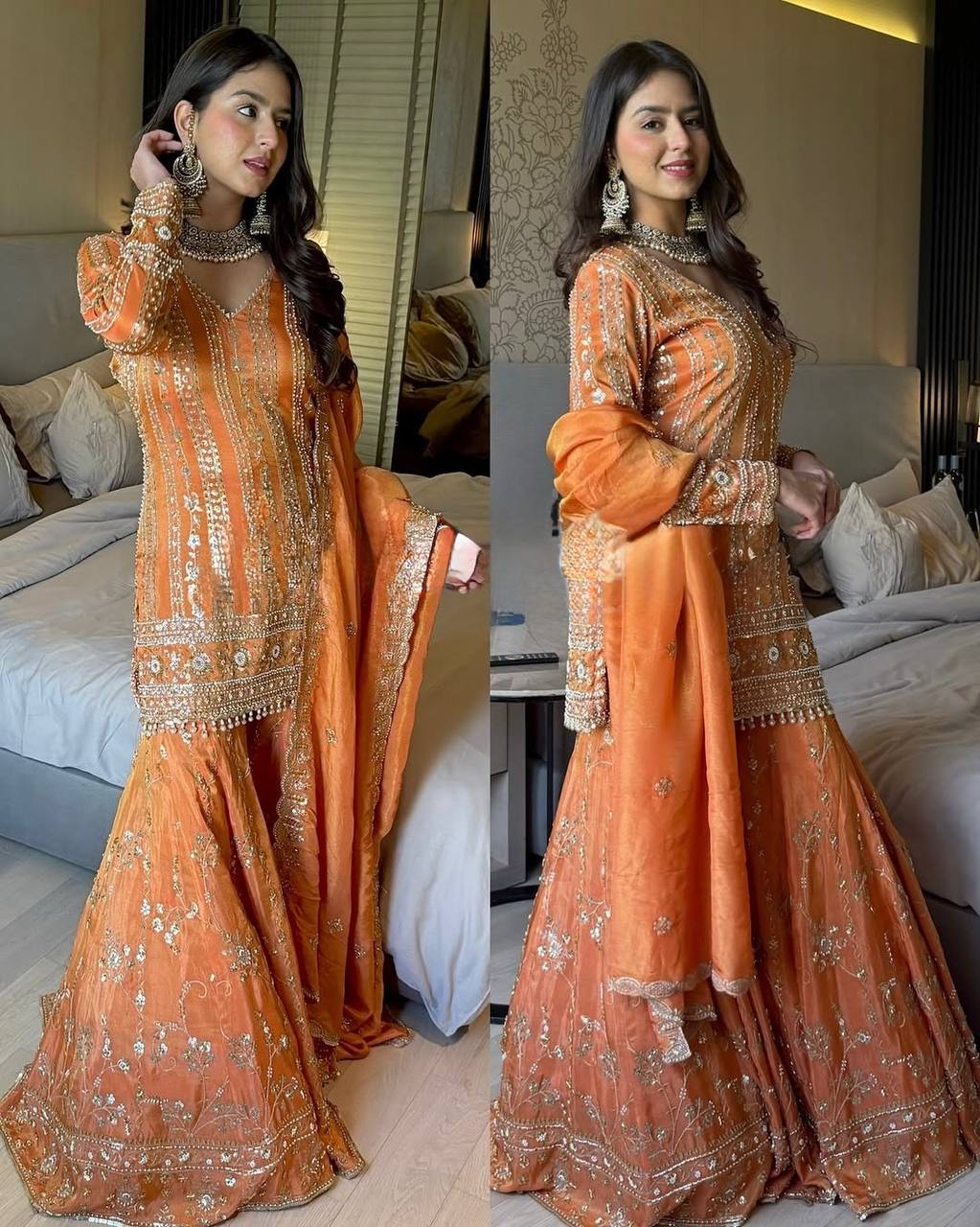 Woman in an orange traditional outfit with intricate designs in a bedroom setting.